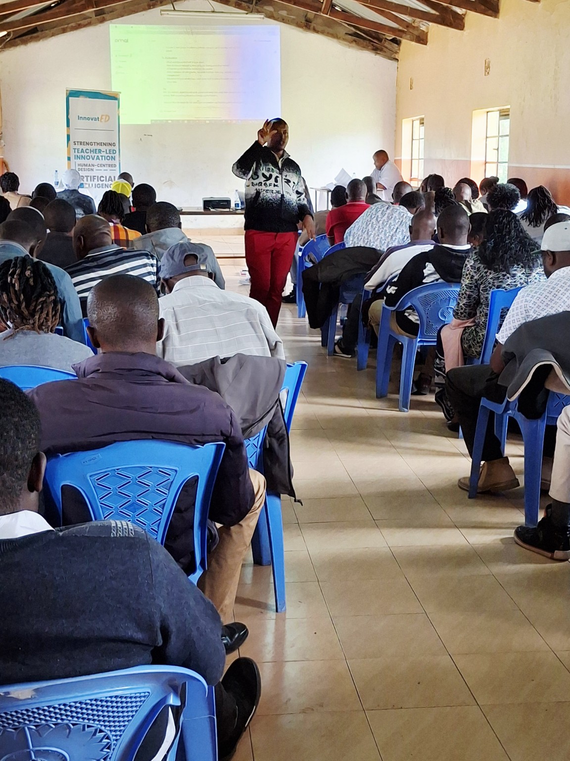 Daniel Kamau facilitating a large teacher training session